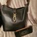 Dooney & Bourke Bags | Dooney & Bourke Logo Lock Toscana Leather Purse | Color: Black | Size: Os