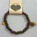 Brandy Melville Jewelry | Brandy Melville Skull Charm Wood Bead Bracelet | Color: Brown/Gold | Size: Os