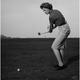 Mid adult woman swinging a golf club on a golf course Poster Print (24 x 36)