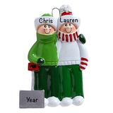 The Holiday Aisle® Snow Shovel Couple Hanging Figurine Ornament Plastic in Green/White | 3.75 H x 2.5 W x 0.5 D in | Wayfair