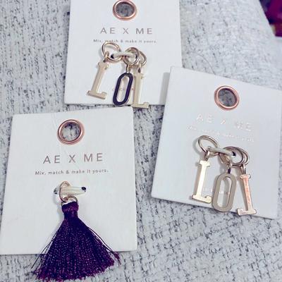 American Eagle Outfitters Jewelry | Gold American Eagle Charms Lol And Purple Tassel | Color: Gold/Purple | Size: Os