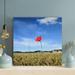 Latitude Run® Red Flower In Green Grass Field During Daytime - 1 Piece Rectangle Graphic Art Print On Wrapped Canvas in Blue/Green | Wayfair