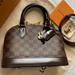Louis Vuitton Bags | Louis Vuitton N41221 Alma Bb Damier Ebene Crossbody Handbag Mif | Color: Brown/Red | Size: 9.3 X 6.9 X 4.5”