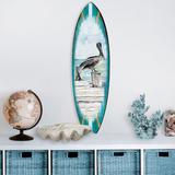 Rosecliff Heights Pelican Surfboard Wooden Wall Décor in Blue/Gray | 24 H x 7 W x 1 D in | Wayfair 5209E9B2C3384CF49B2B24382F68C207