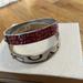 Coach Jewelry | Coach Two Enamel Spellout Coach Bracelets, Stamped In Good Condition Like New | Color: Cream/Red | Size: Os