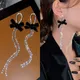 Boucles d'oreilles pendantes en biscuits pour femmes long pompon nœud papillon noir brillant