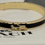 Coach Jewelry | Coach Nwtstunning Black & Gold Bangle W/Classic Horse & Carriage Desig | Color: Black/Gold | Size: Os