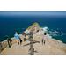 Tourists looking at panoramic view of Cape Point Cape of Good Hope outside Cape Town South Africa shows confluence of Indian Ocean on