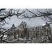 Snow Covered Banff Springs Hotel Framed by Tree Limbs with Snow Covered Trees On Mountain Hillside in The Background - Ba Poster Print by Michael Interisano 19 x 12