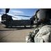 Crew chief of a CH-47 Chinook stands outside the aircraft during start-up procedures Poster Print (17 x 11)