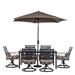 Hanover Montclair 7-Piece Dining Set in Tan with 6 Swivel Rockers 40-In. x 66-In. Dining Table and 9-Ft. Umbrella