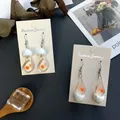 Boucles d'oreilles pendantes en forme d'œuf blanc pour femme bijou créatif en forme de jaune fait