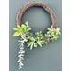 Artificial succulent wreath for indoor or outdoor use. Grapevine wreath with added various succulents and string for hanging.