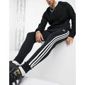 adidas Originals adicolor three stripe skinny joggers in black