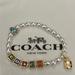 Coach Jewelry | Coach Pearl, Gold, And Silver Stretch Bracelet With Coach Block Letters. | Color: Gold/White | Size: Os