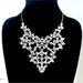 Jessica Simpson Jewelry | Jessica Simpson White Feminine Cutout Plate Bib Necklace Nwt | Color: Gold/White | Size: Os