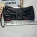 Jessica Simpson Bags | Jessica Simpson Black Pewter Bow Wristlet Clutch | Color: Black/Silver | Size: Os