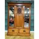 Late Victorian walnut triple wardrobe having mirrored doors either side of a central carved panel.