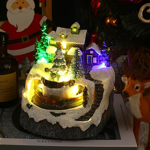 Weihnachtsgeschenk-Lichter mit kleinem Zug, der um das Haus fährt, bunte Lichter, Musik, rotierender Zug, Harz, festliche Verzierung Image