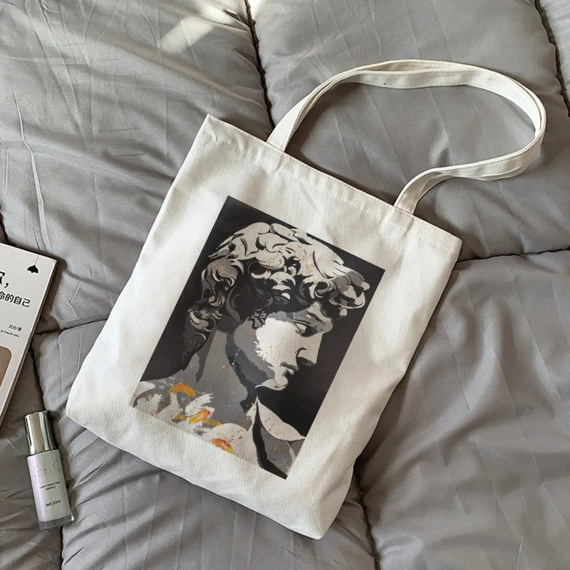 Damen-Canvas-Tragetasche, Umhängetasche, klassische Skulptur, geflügelte Figur, künstlerische Linie, Goldakzente, B&W, Vintage-Kunst, schickes Design, Kunst