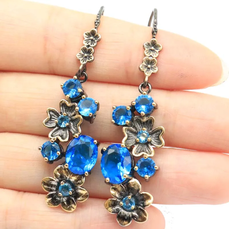 SheCrown Kaufen Sie 5 und erhalten Sie 1 gratis 50 x 14 mm Schweizer Blautopas, grüner Smaragd, violetter Tansanit, schwarze Metall-Silberohrringe Image