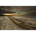 Driftwood on a pebble beach at sunset with dark clouds in a dramatic sky; South Shields Tyne and Wear England Poster Print (38 x 24)