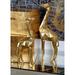 CosmoLiving by Cosmopolitan Gold Polystone Giraffe Sculpture Set of 2 12", 15"H, Rubber in Yellow | 15 H x 5 W x 2 D in | Wayfair 79939