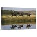 East Urban Home Oregon 'Cowboys Riding Horses w/ Dogs Running Beside Pond' Photographic Print on Wrapped Canvas in Gray/Green | Wayfair